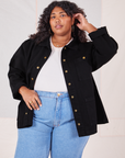 Morgan is wearing Denim Work Jacket in Basic Black with a vintage off-white Baby Tee underneath paired with light wash jeans
