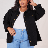 Morgan is wearing Denim Work Jacket in Basic Black with a vintage off-white Baby Tee underneath paired with light wash jeans