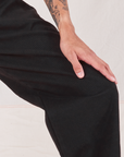 Heritage Trousers in Basic Black pant leg close up on Jesse