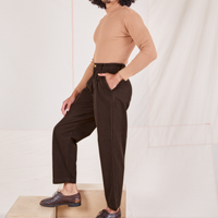 Side view of Heritage Trousers in Espresso Brown and tan Essential Turtleneck worn by Jesse