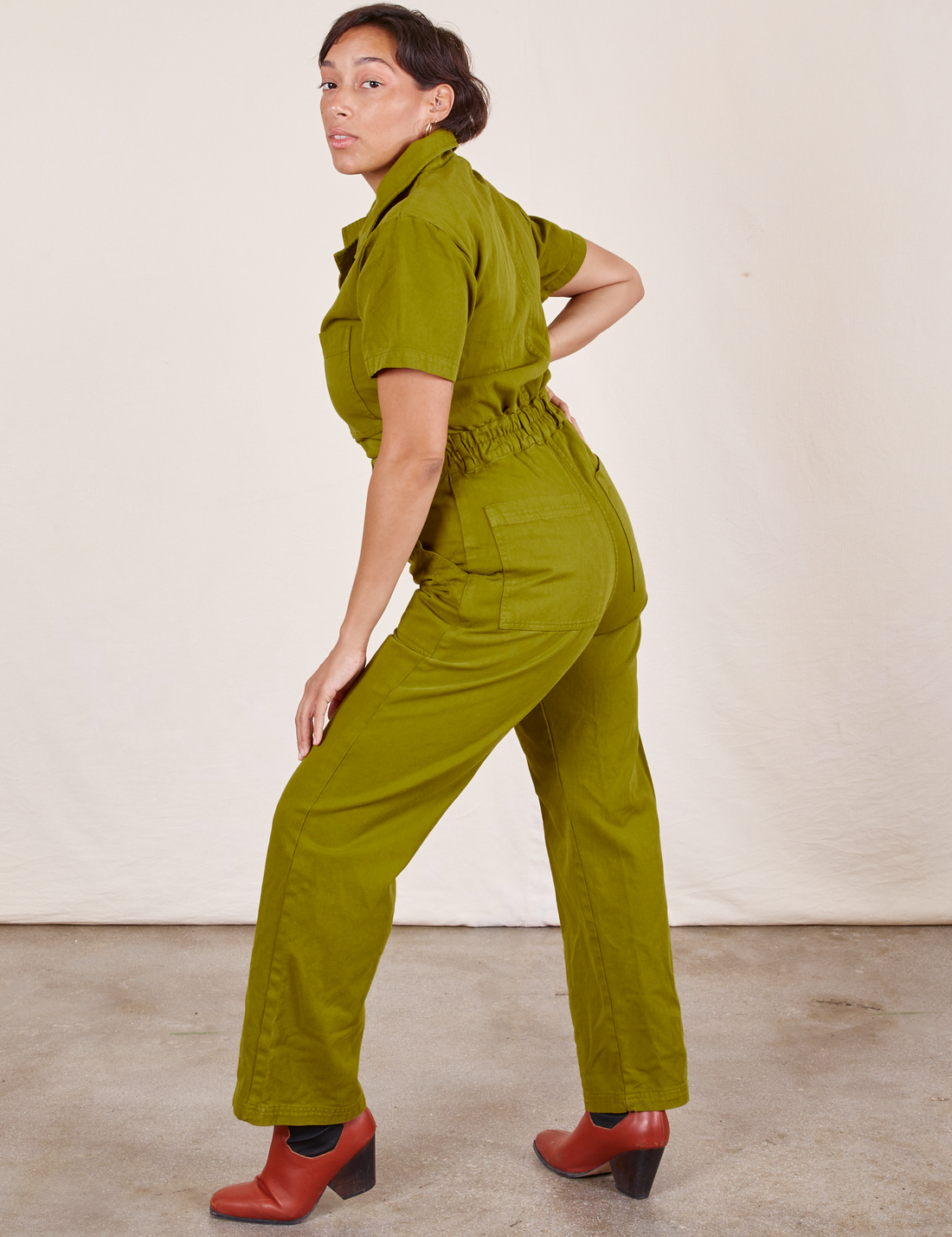 Side view of Short Sleeve Jumpsuit in Olive Green worn by Tiara