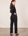 Angled back view of Everyday Jumpsuit in Basic Black worn by Alex