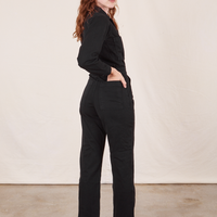 Angled back view of Everyday Jumpsuit in Basic Black worn by Alex