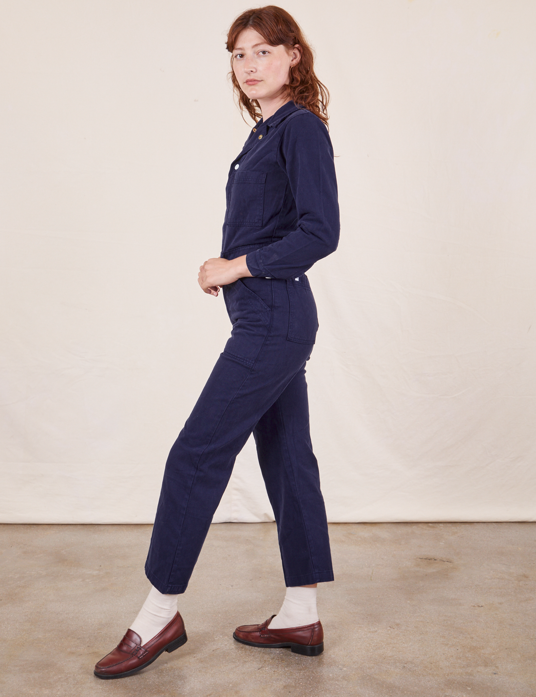 Side view of Everyday Jumpsuit in Navy Blue worn by Alex