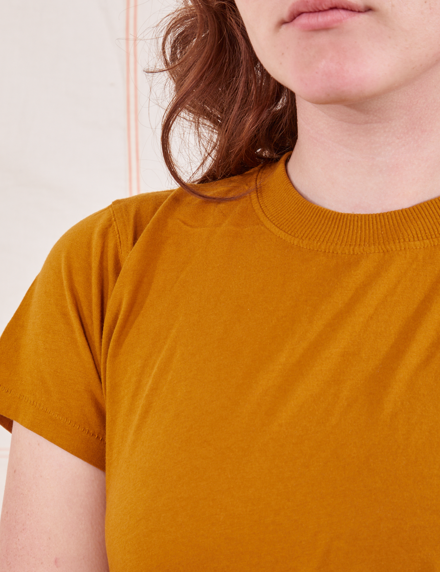 The Organic Vintage Tee in Spicy Mustard front close up on Alex