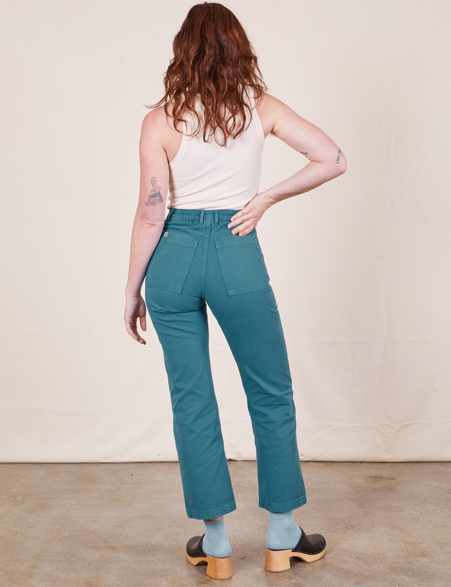 Work Pants in Marine Blue back view on Alex wearing vintage off-white Tank Top