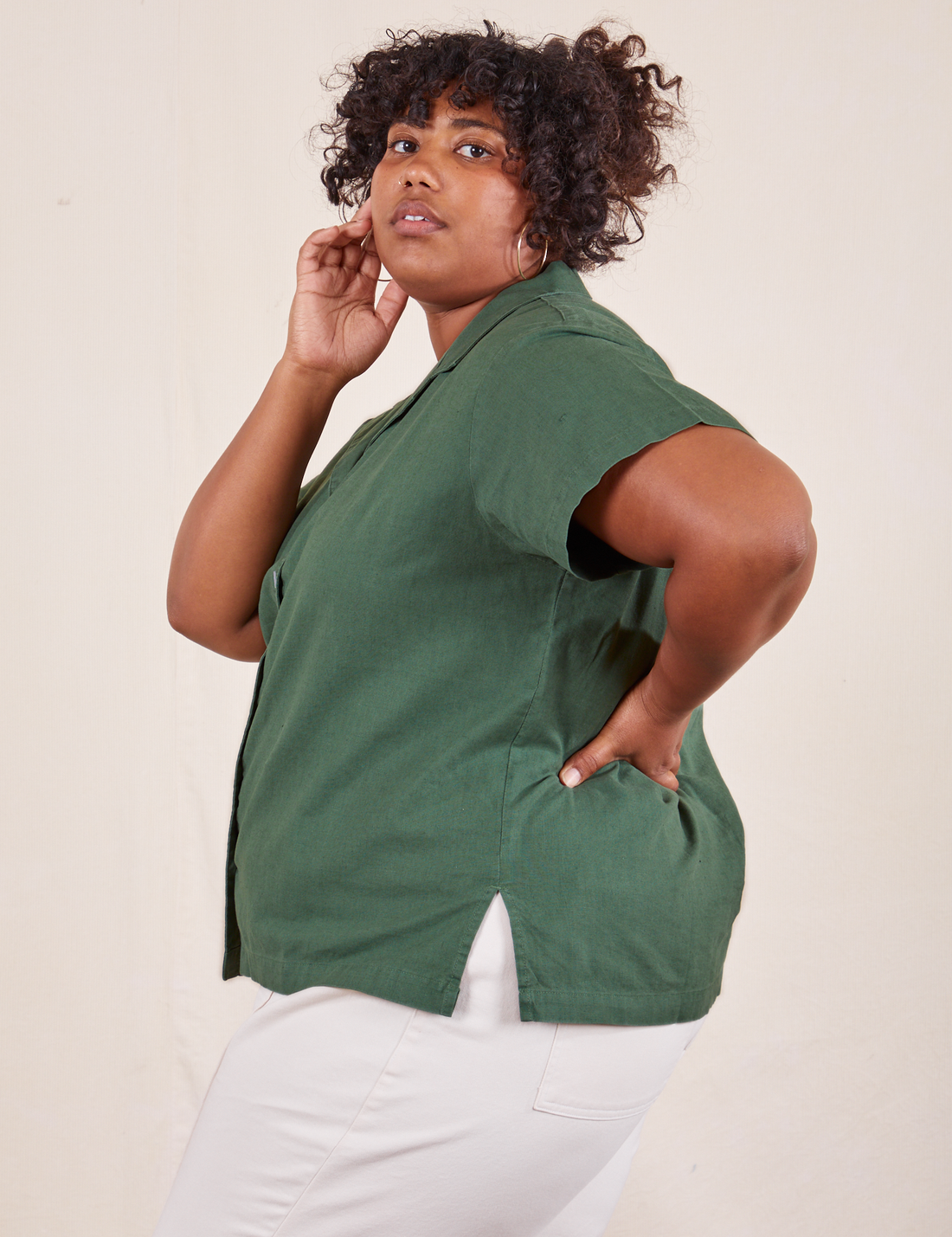 Side view of Pantry Button-Up in Dark Emerald Green worn by Morgan