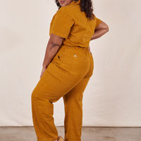 Side view of Short Sleeve Jumpsuit in Spicy Mustard worn by Morgan
