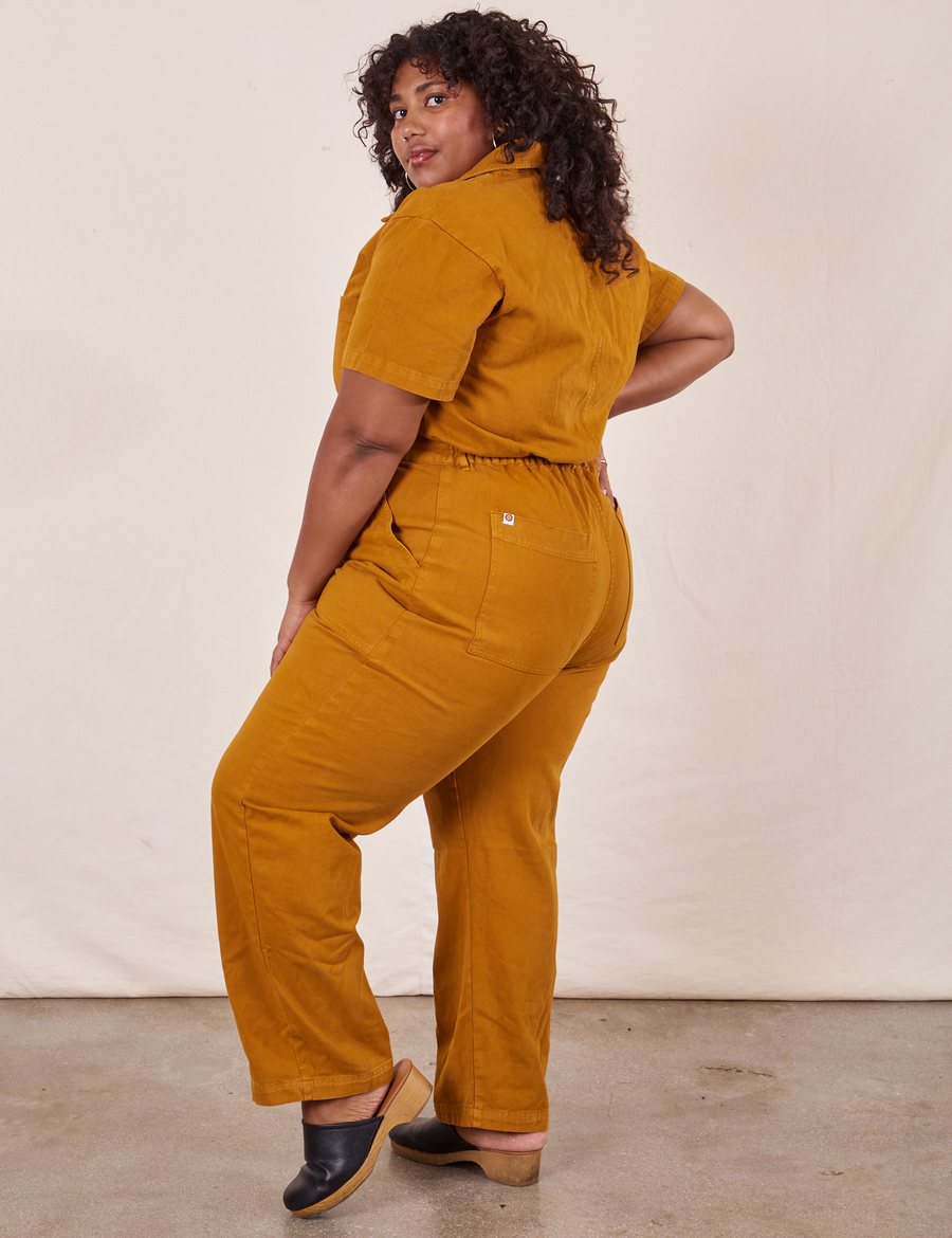 Side view of Short Sleeve Jumpsuit in Spicy Mustard worn by Morgan