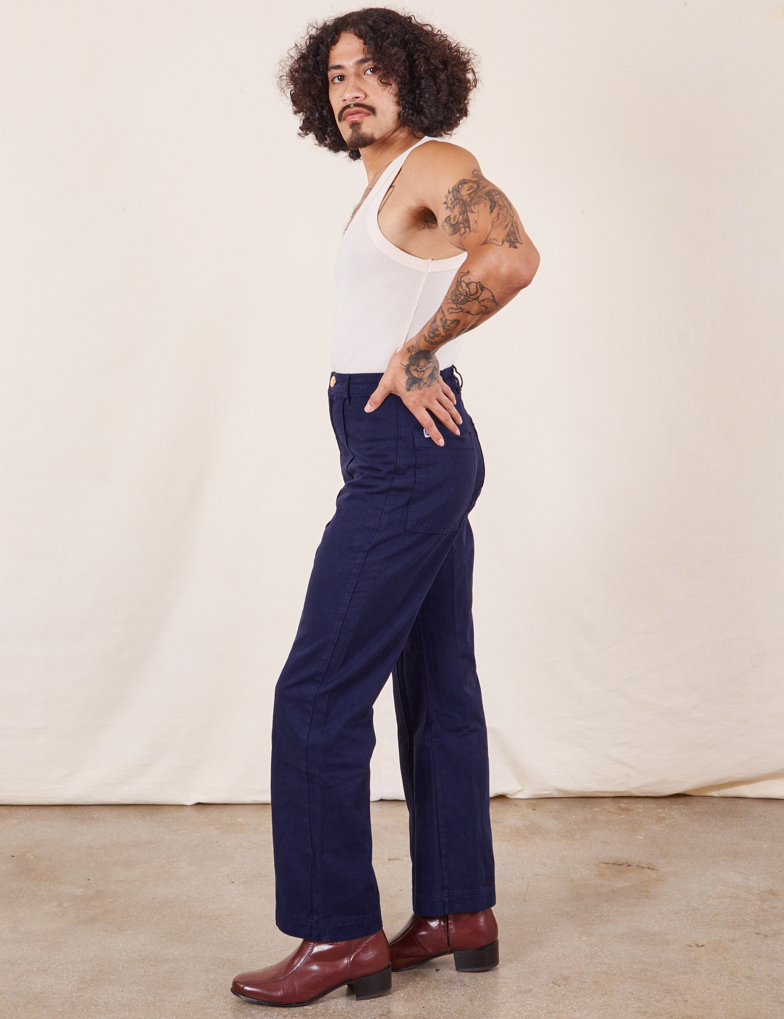 Side view of Western Pants in Navy Blue and vintage off-white Tank Top