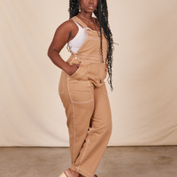 Angled view of Original Overalls in Tan worn by Shai