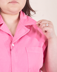 Short Sleeve Jumpsuit in Bubblegum Pink front close up on Ashley holding collar