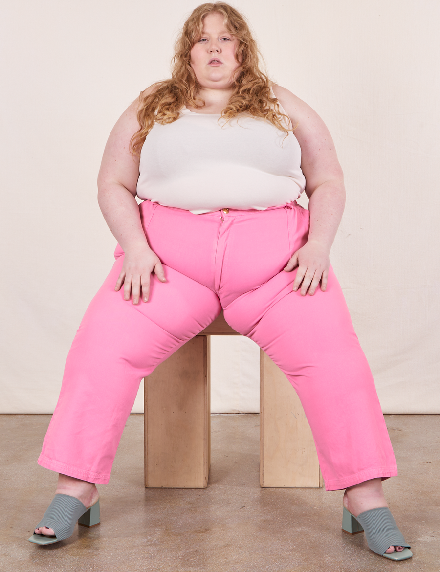 Work Pants in Bubblegum Pink on Catie wearing vintage off-white Tank Top sitting on wooden crate