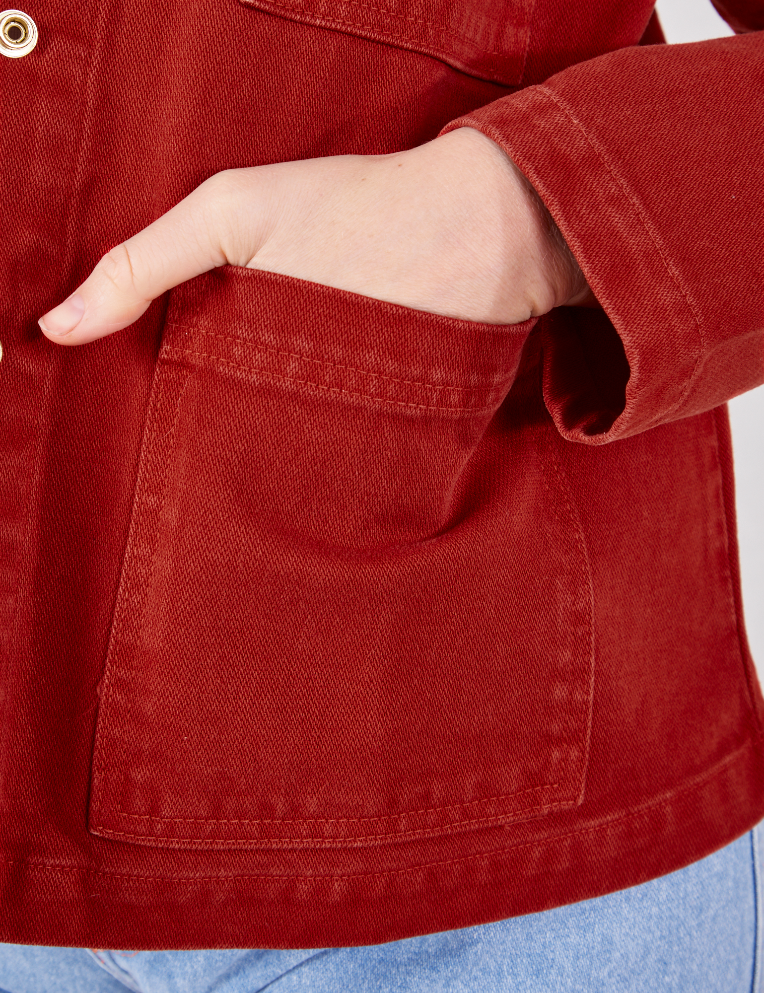 Denim Work Jacket in Paprika hand in front bottom pocket close up