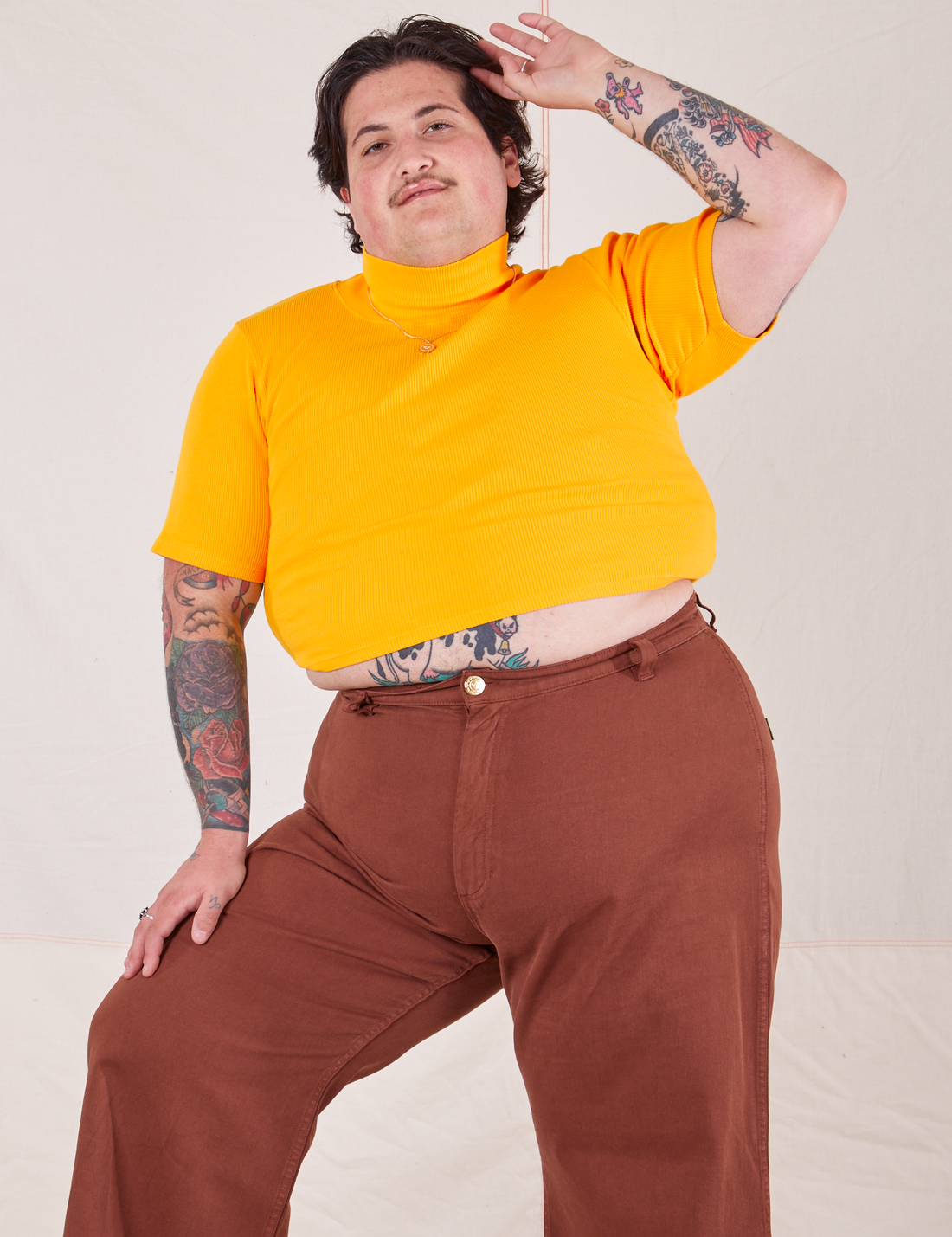 1/2 Sleeve Essential Turtleneck in Sunshine Yellow on Sam wearing fudgesicle brown Bell Bottoms