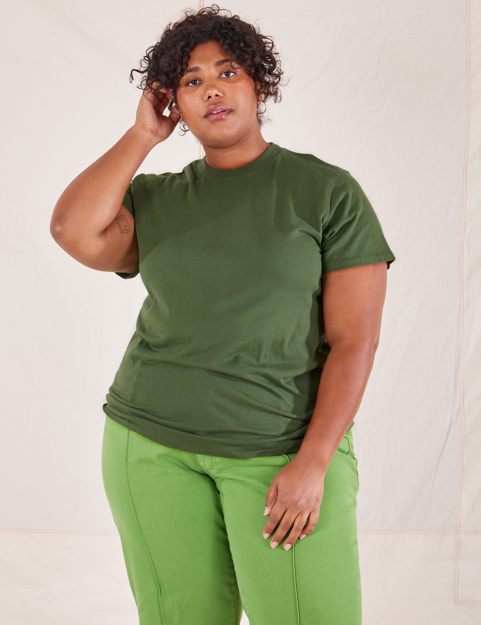 Morgan is wearing Organic Vintage Tee in Dark Emerald Green and gross green Western Pants