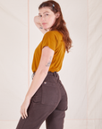 Side view of Organic Vintage Tee in Spicy Mustard and espresso brown Western Pants worn by Alex
