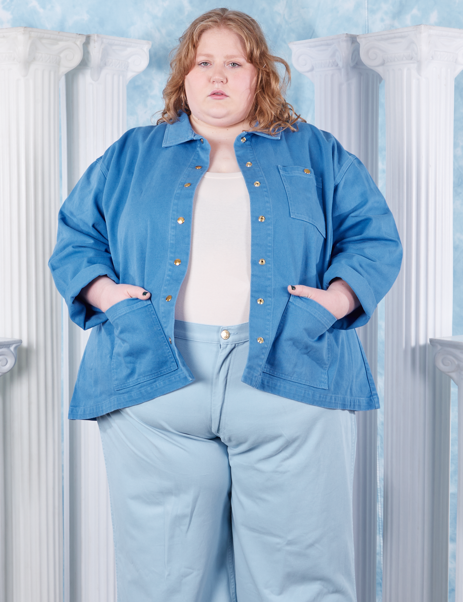 Catie is wearing 4XL Neoclassical Work Jacket in Blue Venus paired with vintage off-white Tank Top and baby blue Bell Bottoms