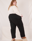 Angled back view of Organic Work Pants in Basic Black worn by Catie