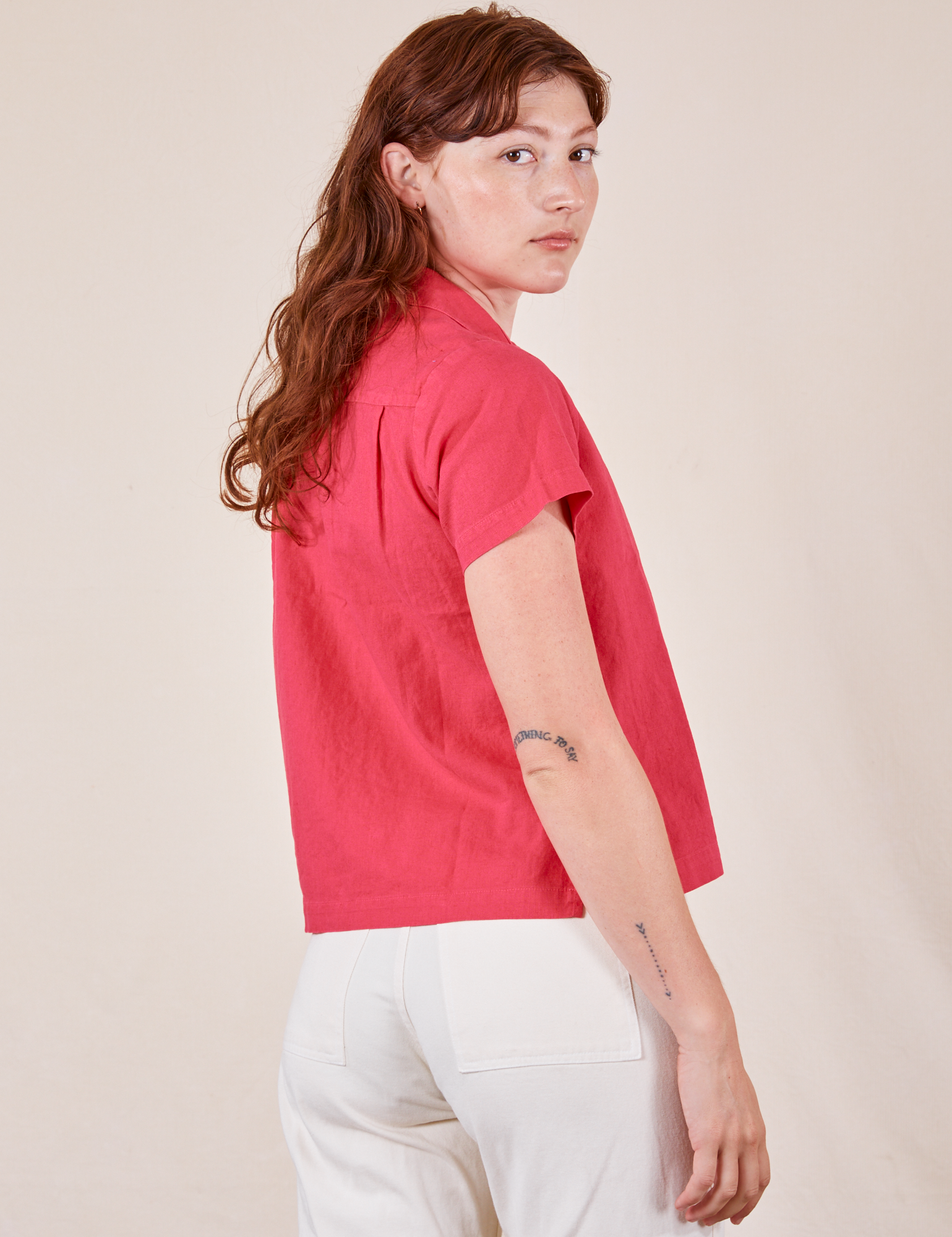 Angled back view of Pantry Button-Up in Hot Pink worn by Alex