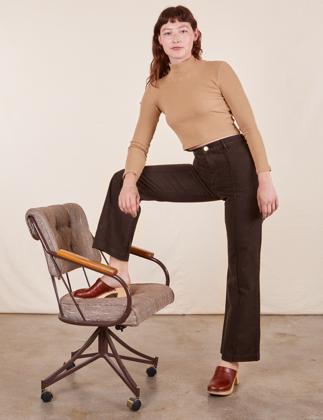 Western Pants in Espresso Brown paired with tan Essential Turtleneck worn by Alex
