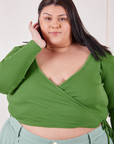 Sarita is wearing size 5 Wrap Top in Bright Olive