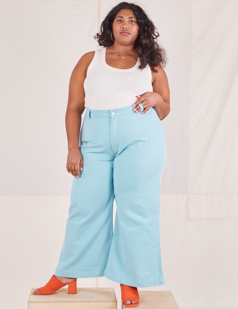 Morgan is 5'5" and wearing 1XL Bell Bottoms in Baby Blue paired with vintage off-white Tank Top