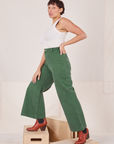 Side view of Bell Bottoms in Dark Emerald Green and vintage off-white Tank Top worn by Tiara