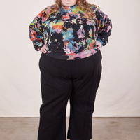 Catie is wearing 4XL Heavyweight Crew in Rainbow Magic Waters paired with black Western Pants