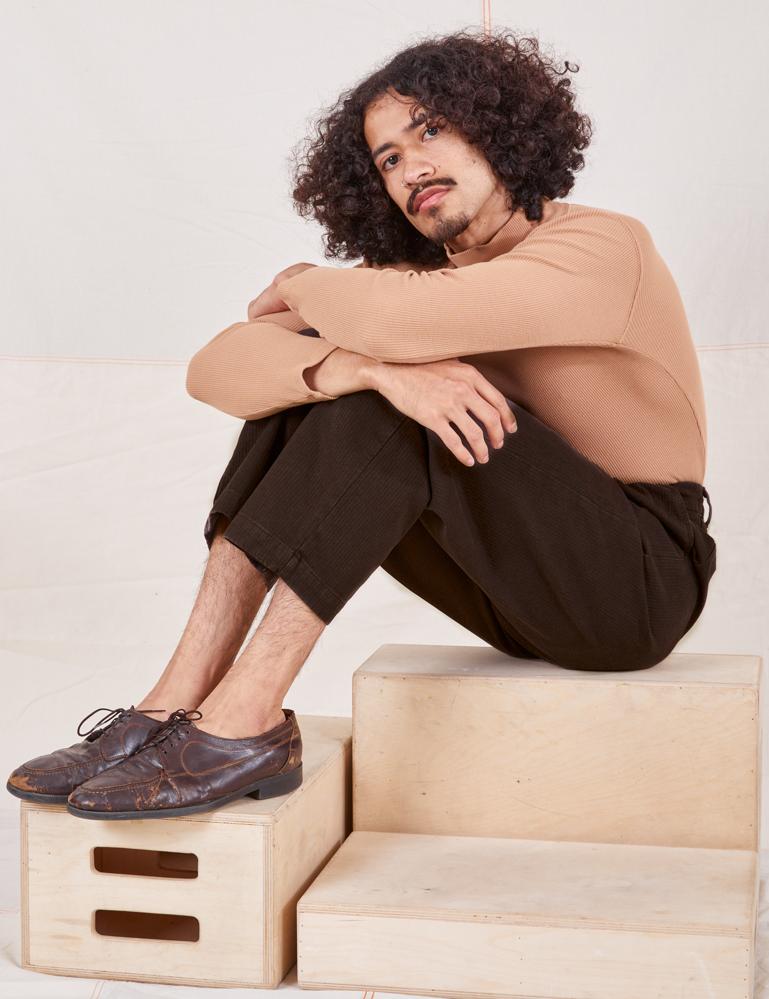 Heritage Trousers in Espresso Brown on Jesse wearing tan Essential Turtleneck