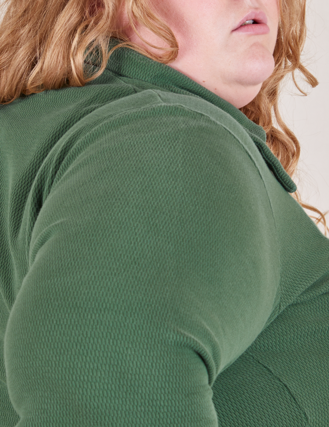 Shoulder close up of Long Sleeve Fisherman Polo in Dark Emerald Green worn by Catie