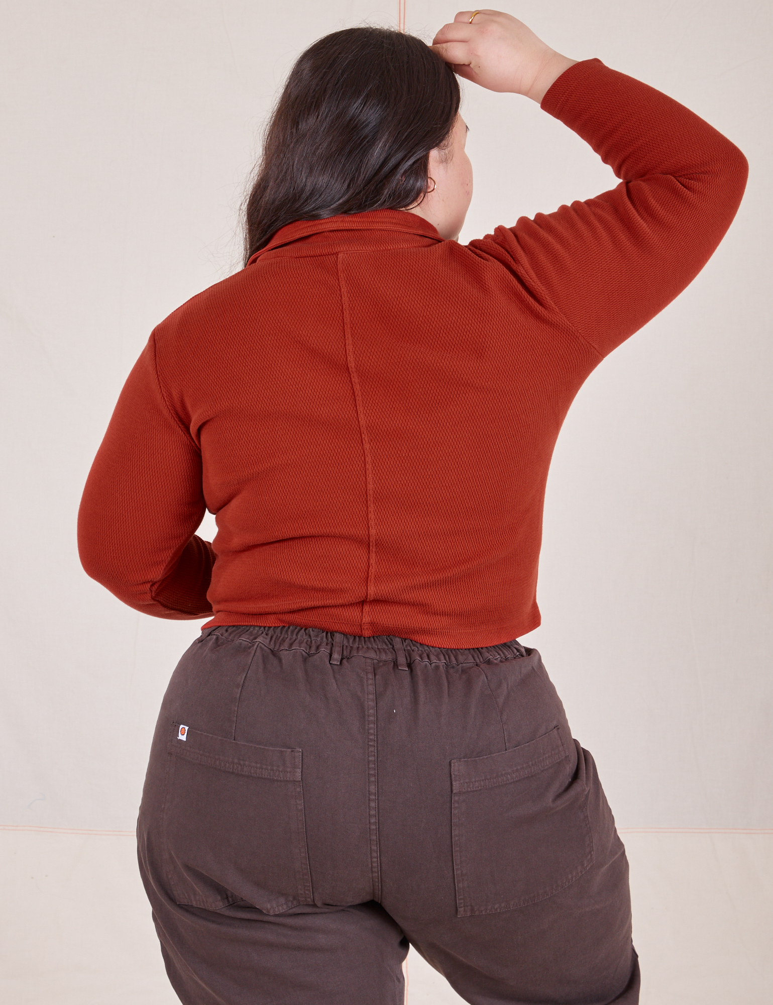 Back view of Long Sleeve Fisherman Polo in Paprika worn by Ashley