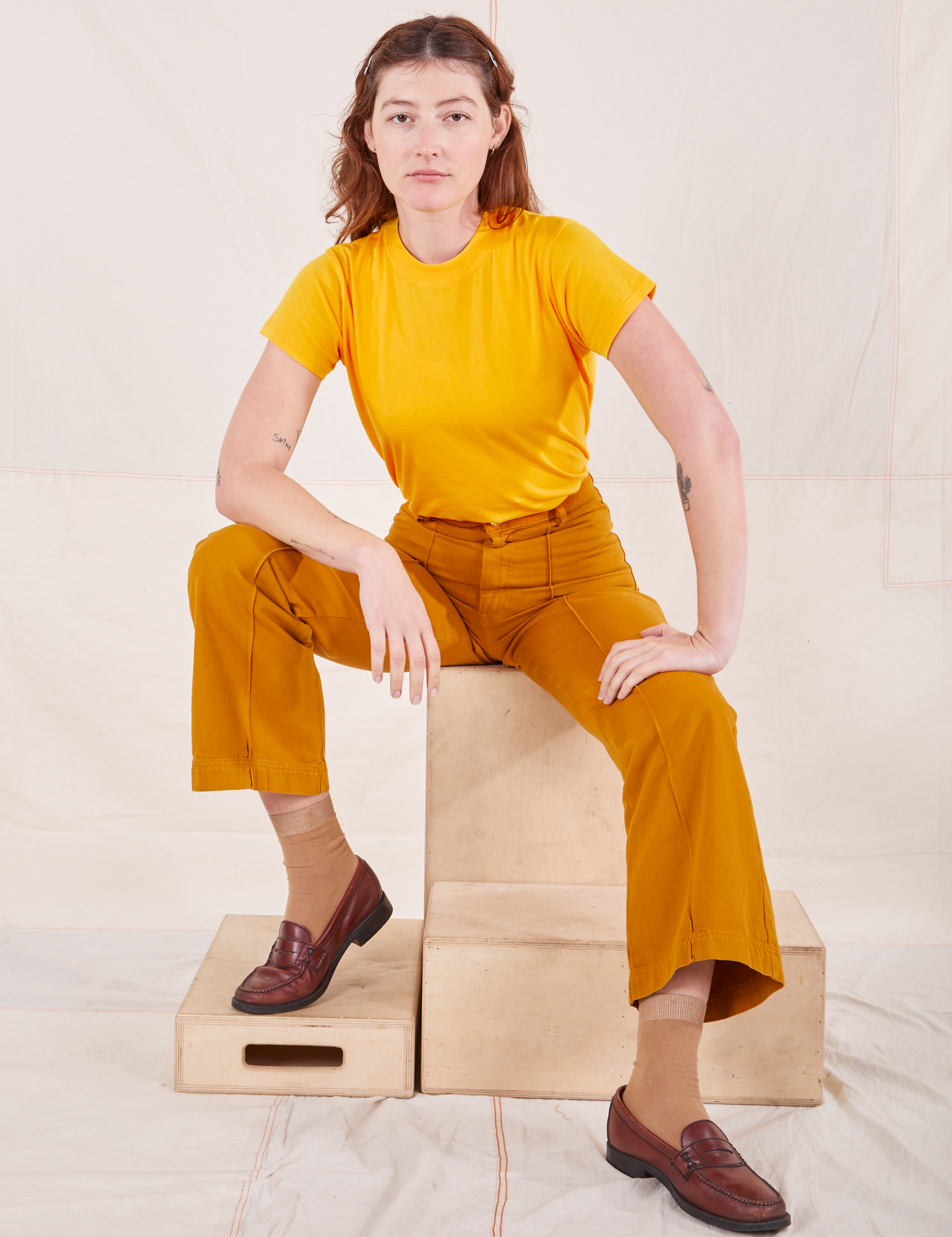 Alex is wearing Organic Vintage Tee in Sunshine Yellow and spicy mustard Western Pants
