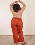 Back view of Western Pants in Burnt Terracotta and tan Essential Turtleneck on Morgan