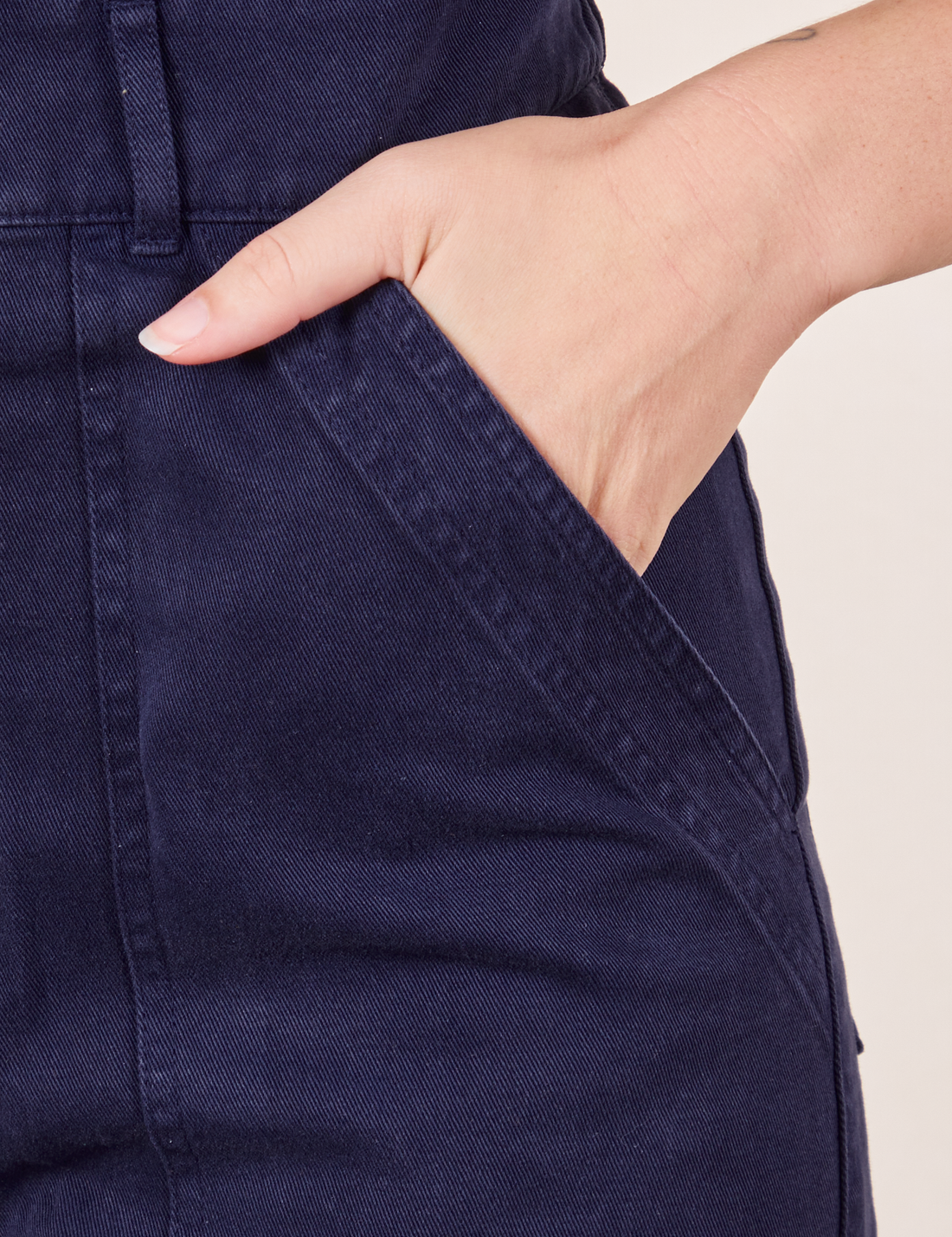 Short Sleeve Jumpsuit in Navy Blue hand in pant pocket on Alex