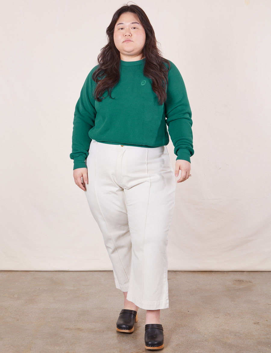 Ashley is wearing M Heavyweight Crew in Hunter Green paired with vintage off-white Western Pants