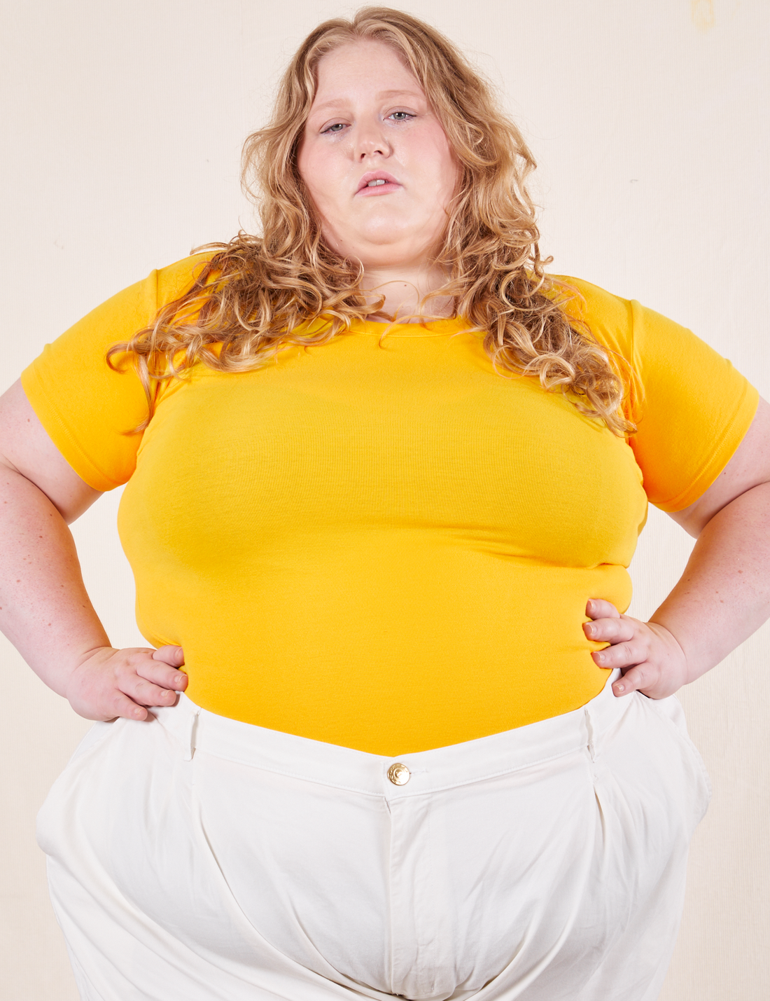 Catie is wearing size 3XL Baby Tee in Sunshine Yellow