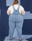 Back view of Indigo Denim Original Overalls in Light Wash worn by Catie