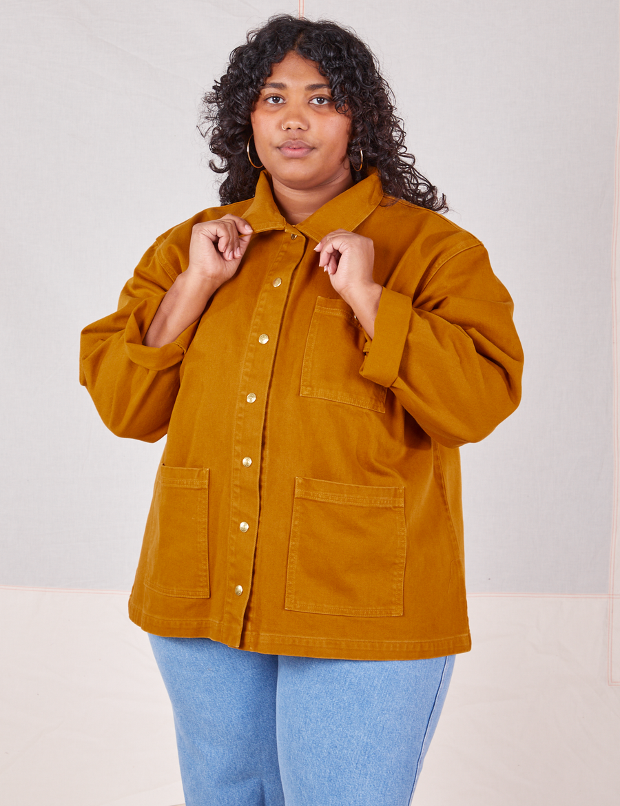 Morgan is wearing a buttoned up Denim Work Jacket in Spicy Mustard