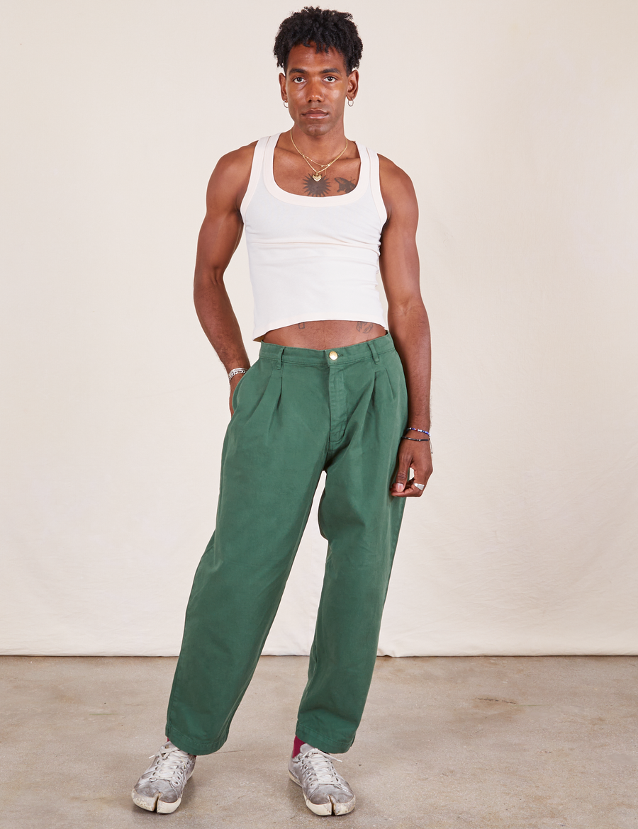 Jerrod is 6'1" and wearing M Heavyweight Trousers in Dark Emerald Green paired with a vintage off-white Tank Top
