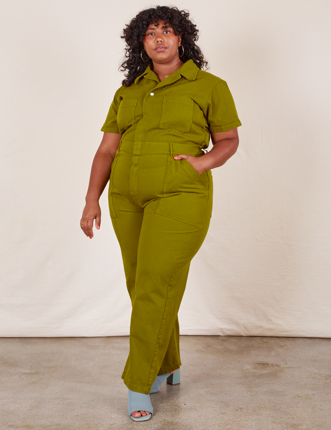 Morgan is 5'5" and wearing 2XL Short Sleeve Jumpsuit in Olive Green