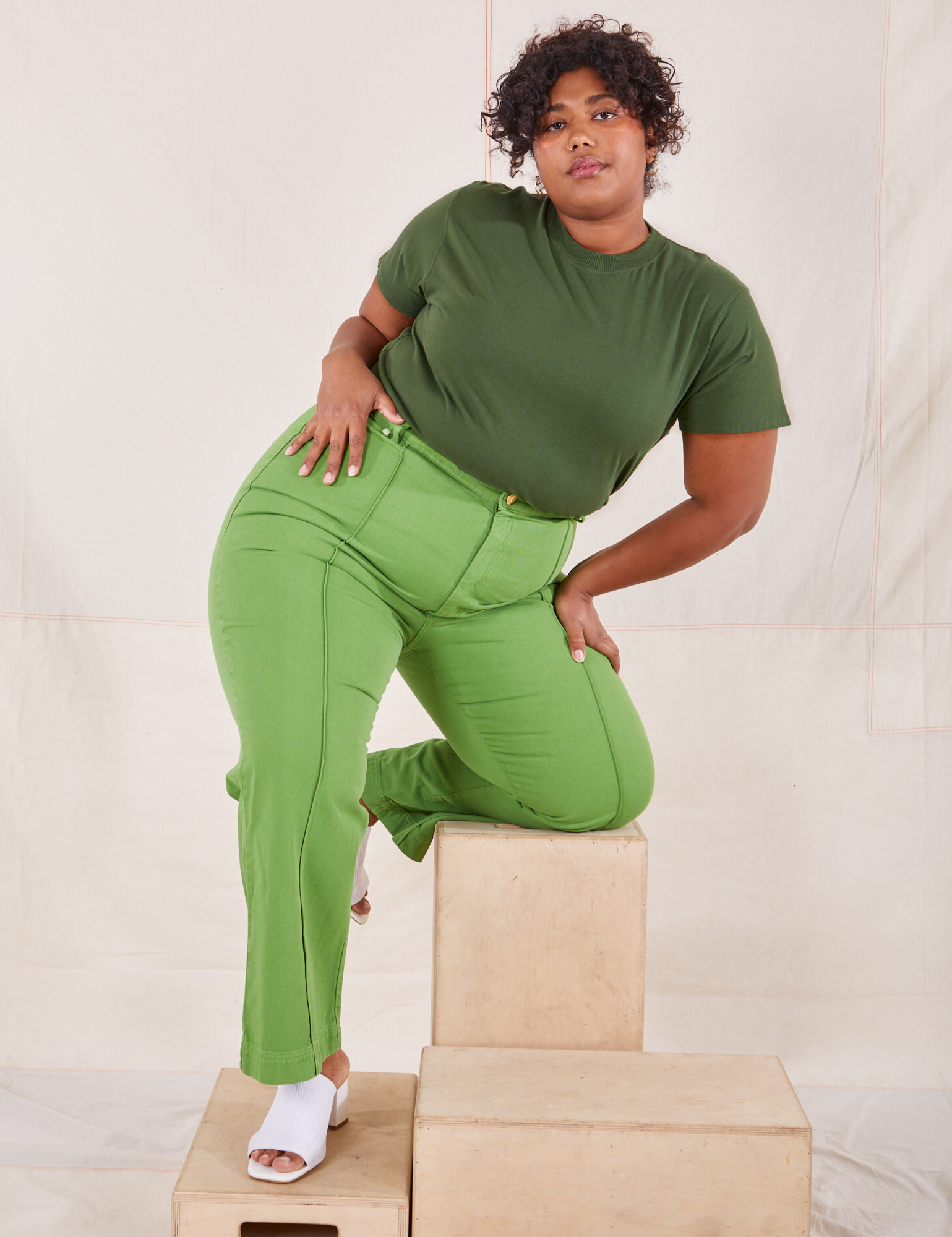 Morgan is wearing Organic Vintage Tee in Dark Emerald Green and gross green Western Pants