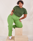 Morgan is wearing Organic Vintage Tee in Dark Emerald Green and gross green Western Pants