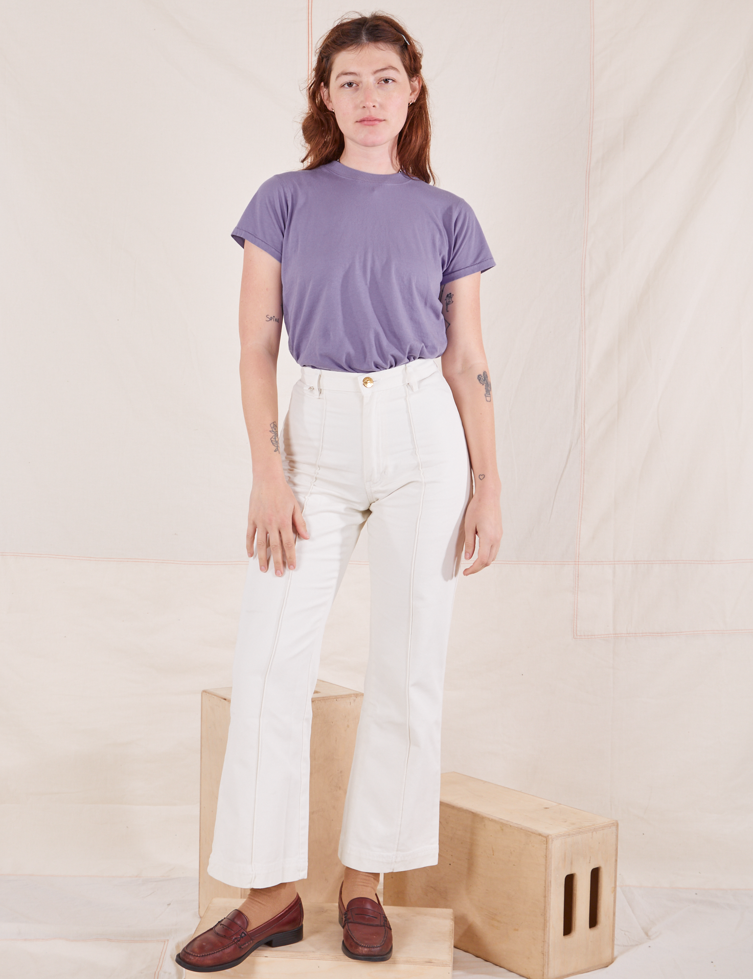 Alex is wearing P Organic Vintage Tee in Faded Grape paired with vintage off-white Western Pants