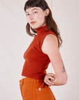 Side view of Sleeveless Essential Turtleneck in Paprika worn by Alex