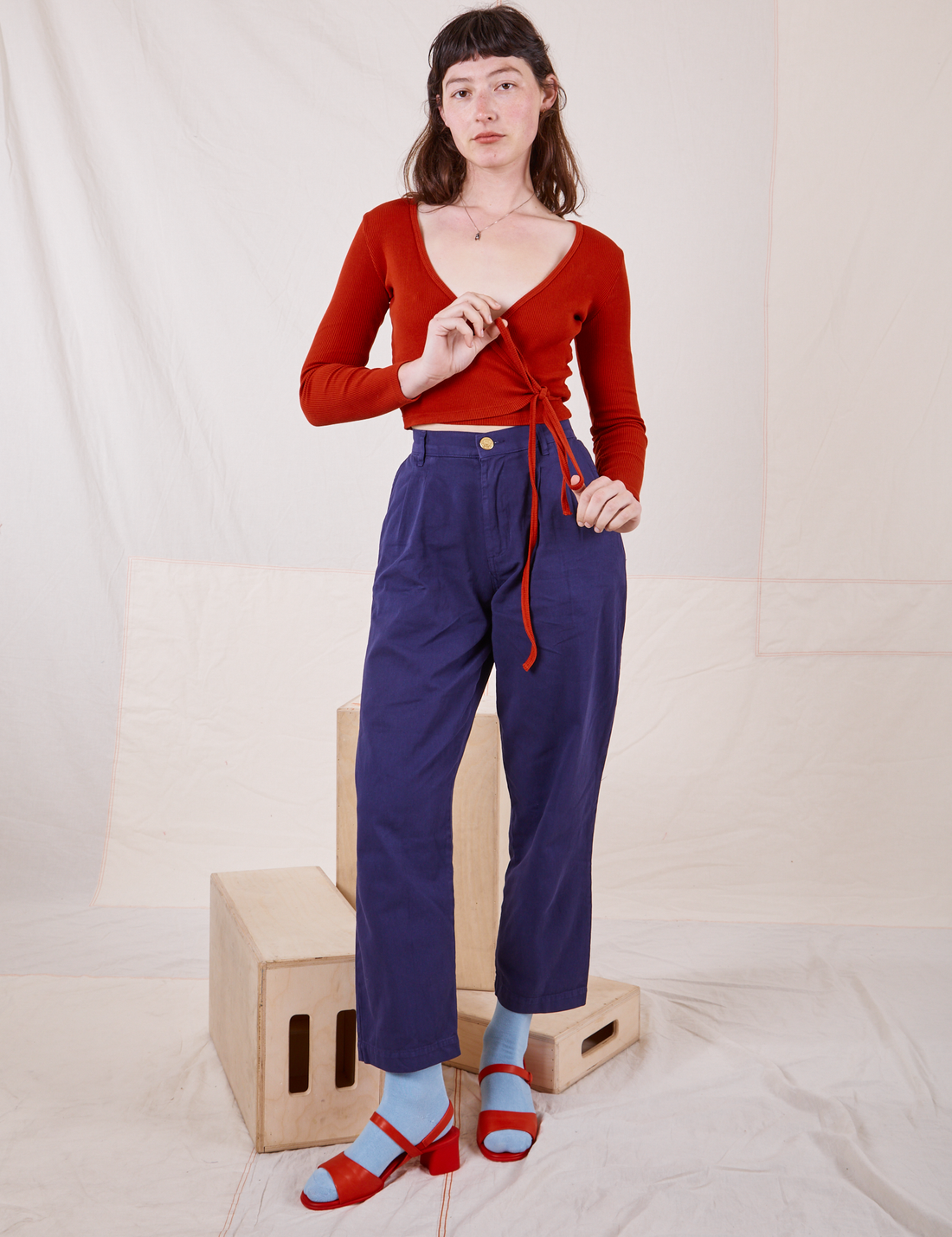Wrap Top in Paprika on Alex wearing Navy Blue trousers