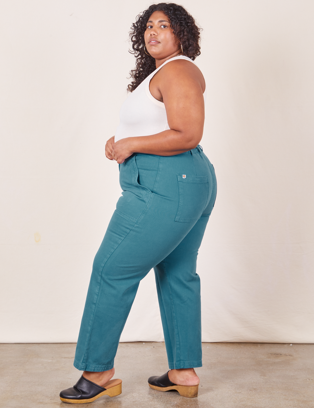 Work Pants in Marine Blue side view on Morgan wearing vintage off-white Tank Top