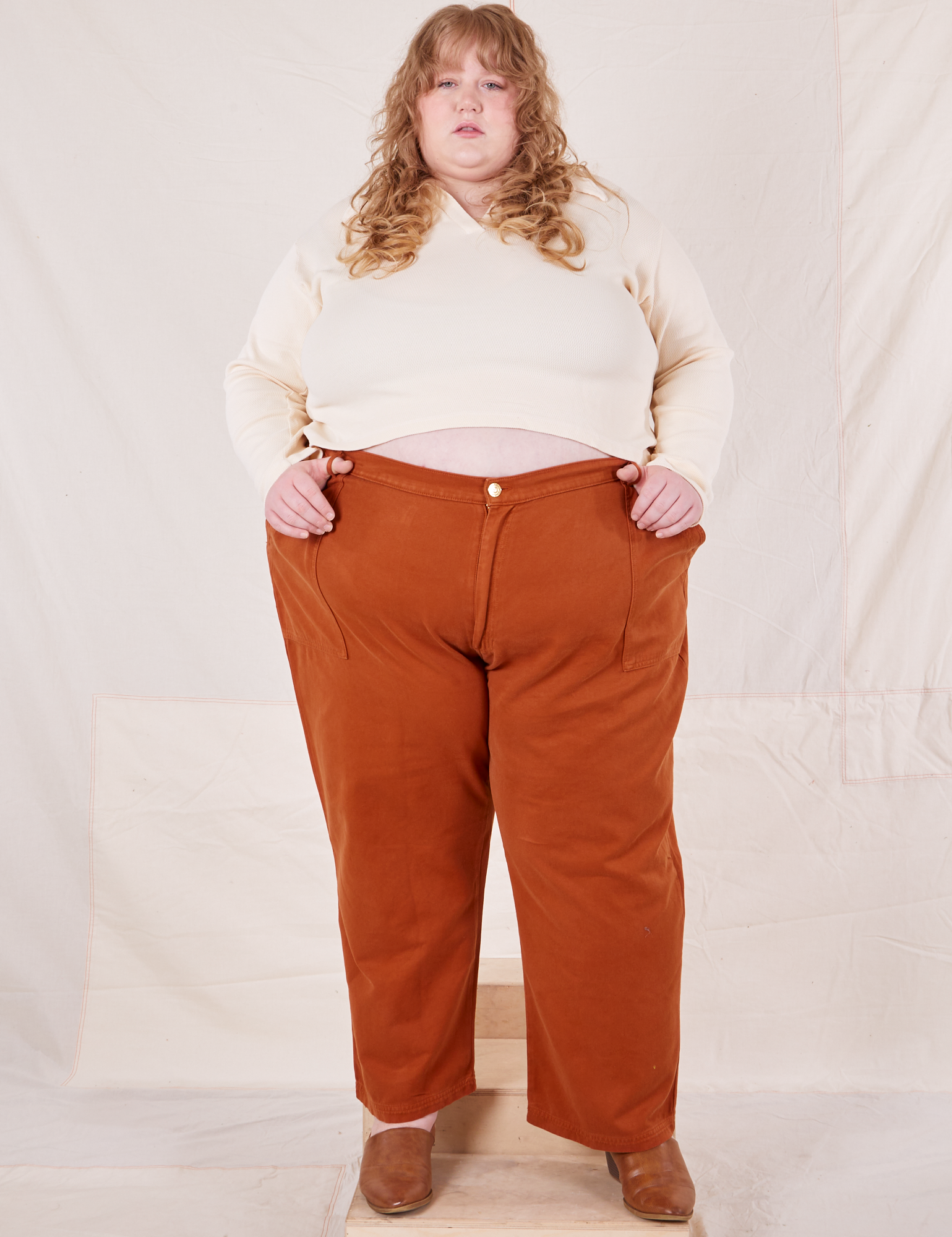 Catie is 5&#39;11&quot; and wearing 5XL Organic Work Pants in Burnt Terracotta paired with vintage off-white Long Sleeve Fisherman Polo