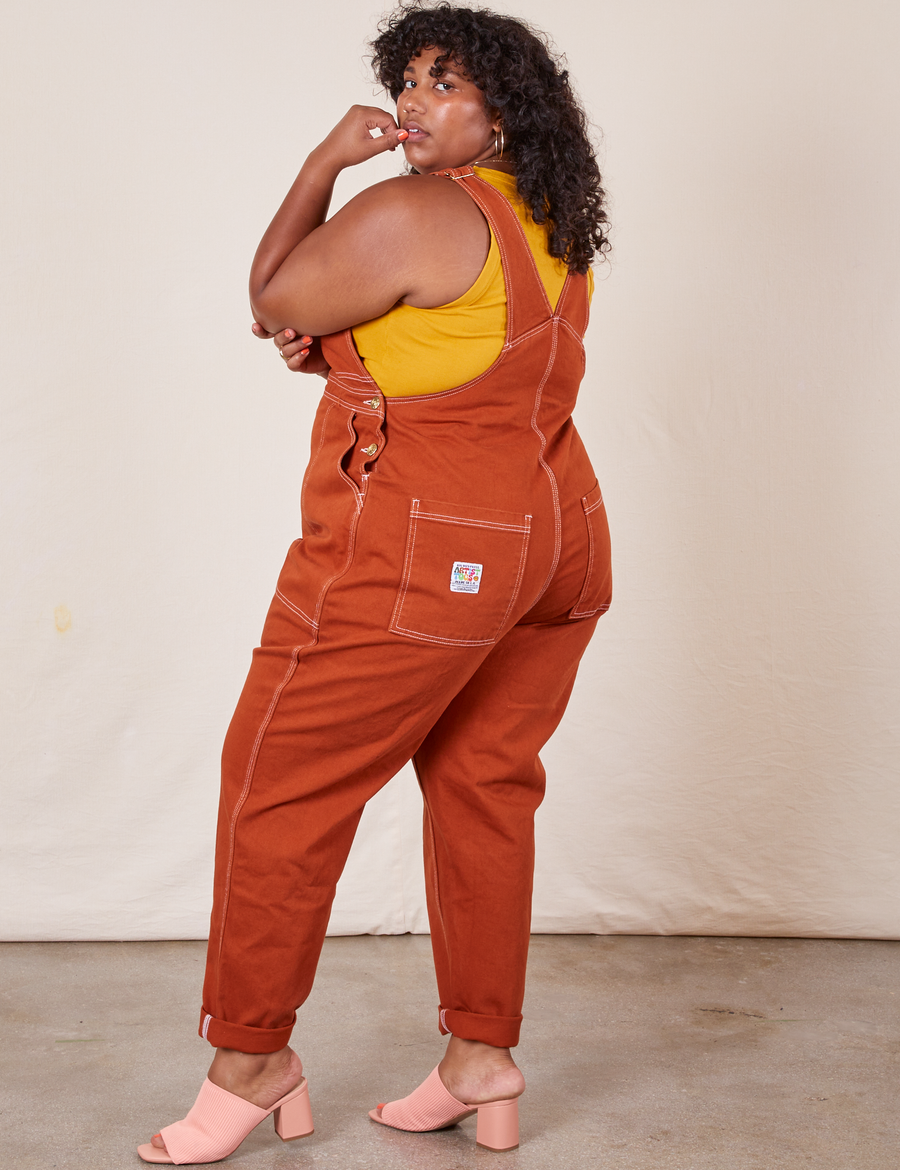 Angled back view of Original Overalls in Burnt Terracotta worn by Morgan