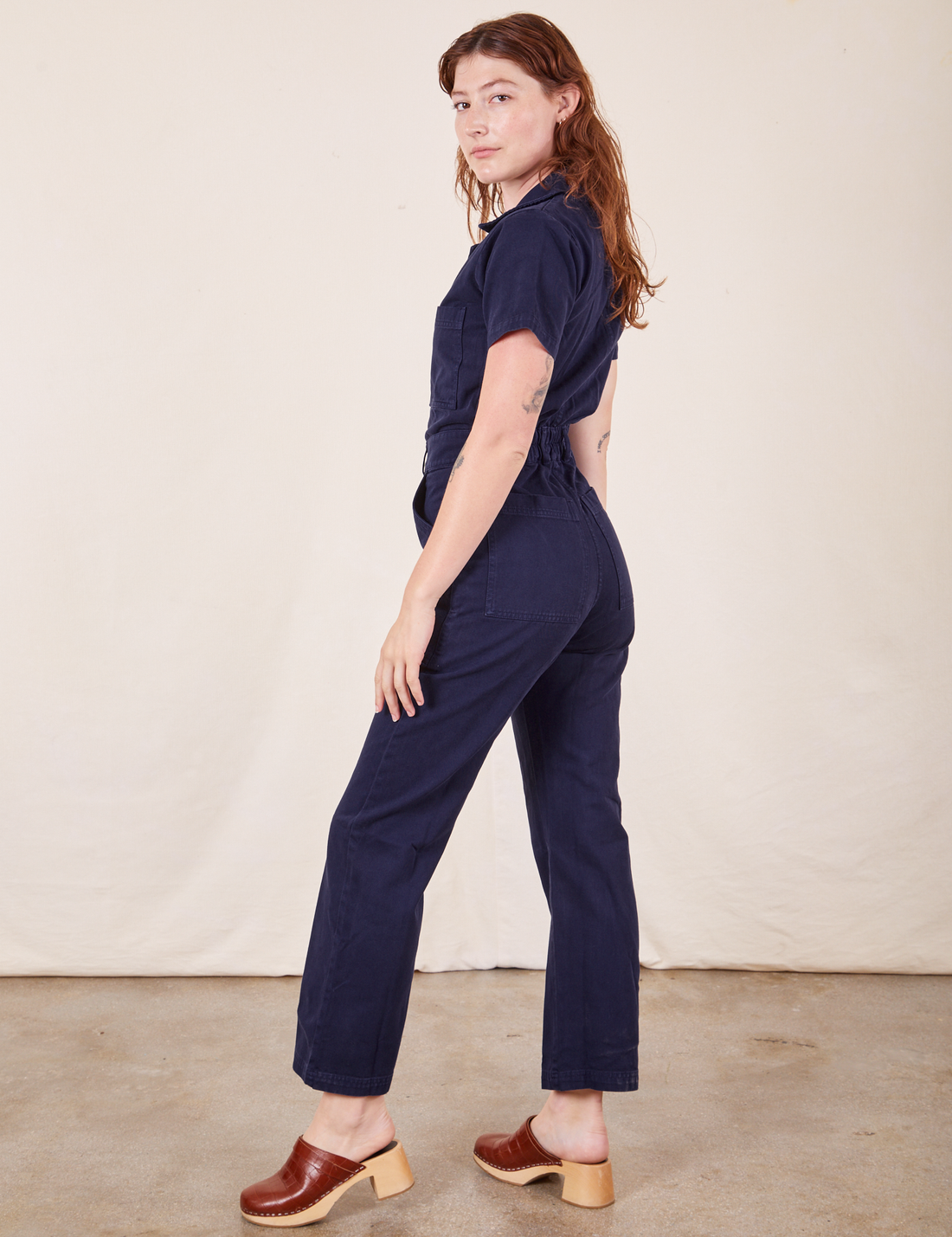 Side view of Short Sleeve Jumpsuit in Navy Blue worn by Alex